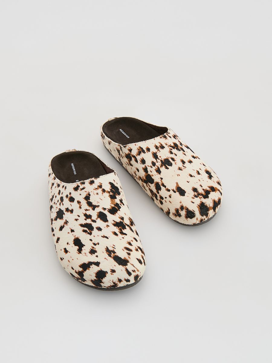 Leather mules with animal motif
