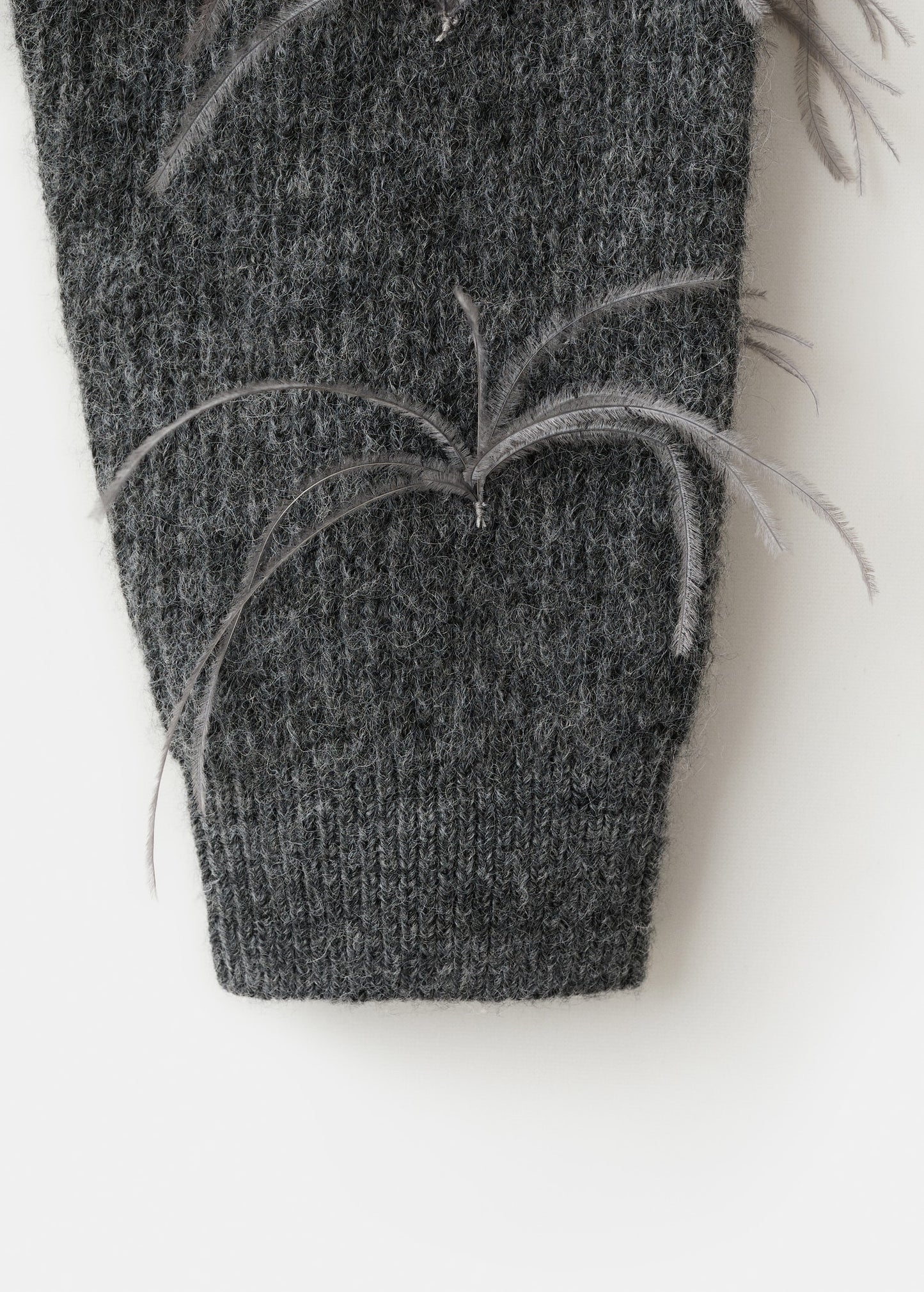 Knitted sweater with feathers