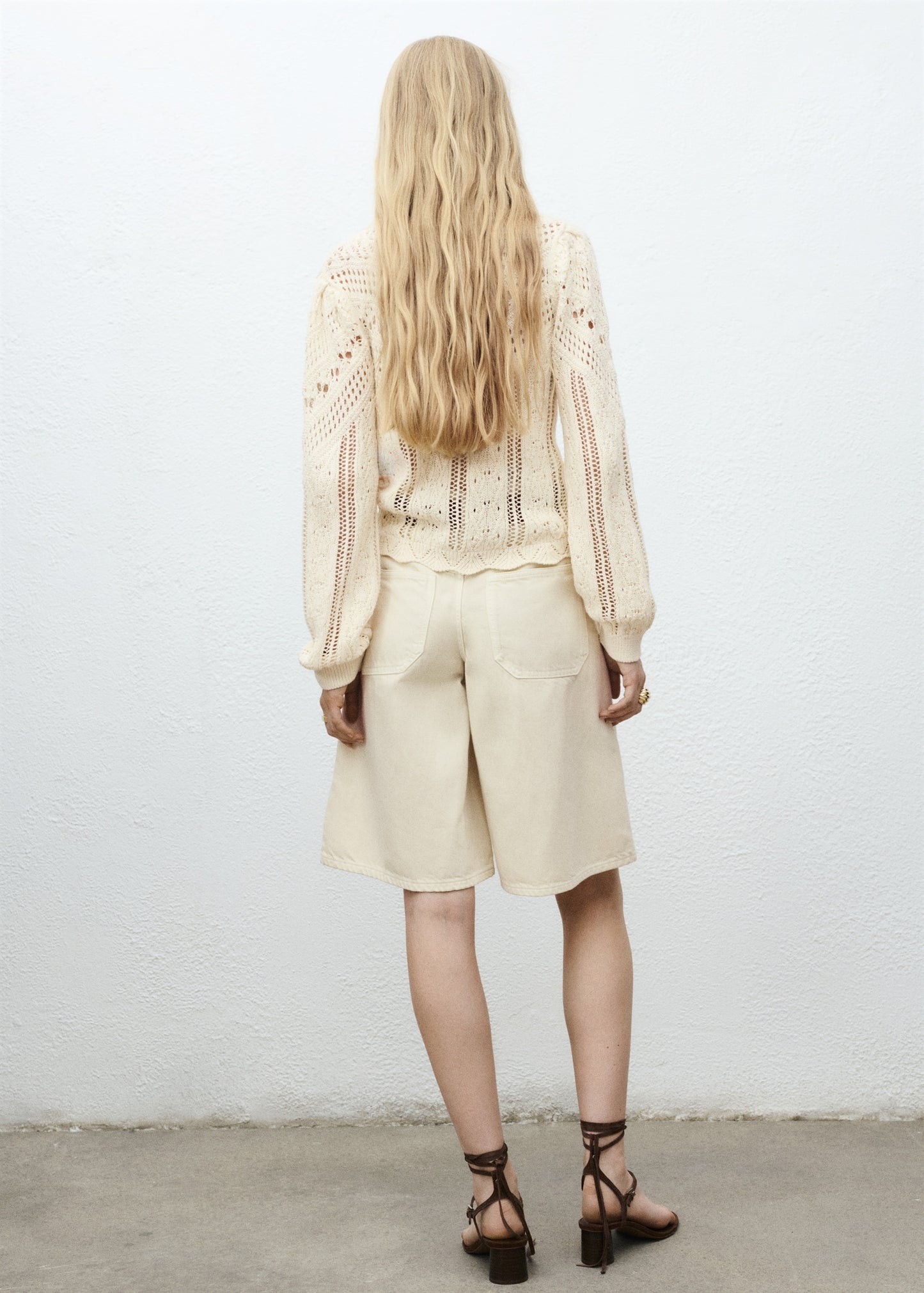 Knitted sweater with openwork details