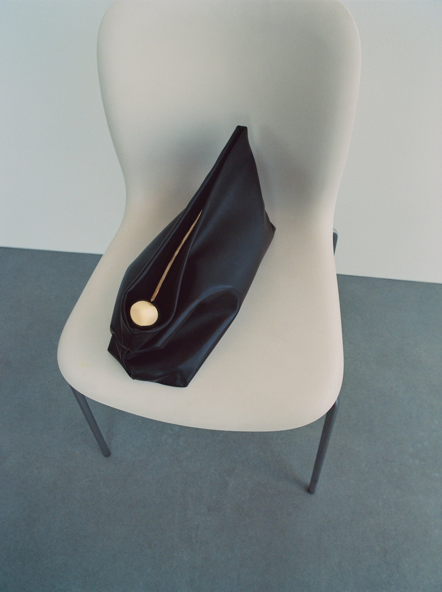 Leather clutch bag with metallic detail
