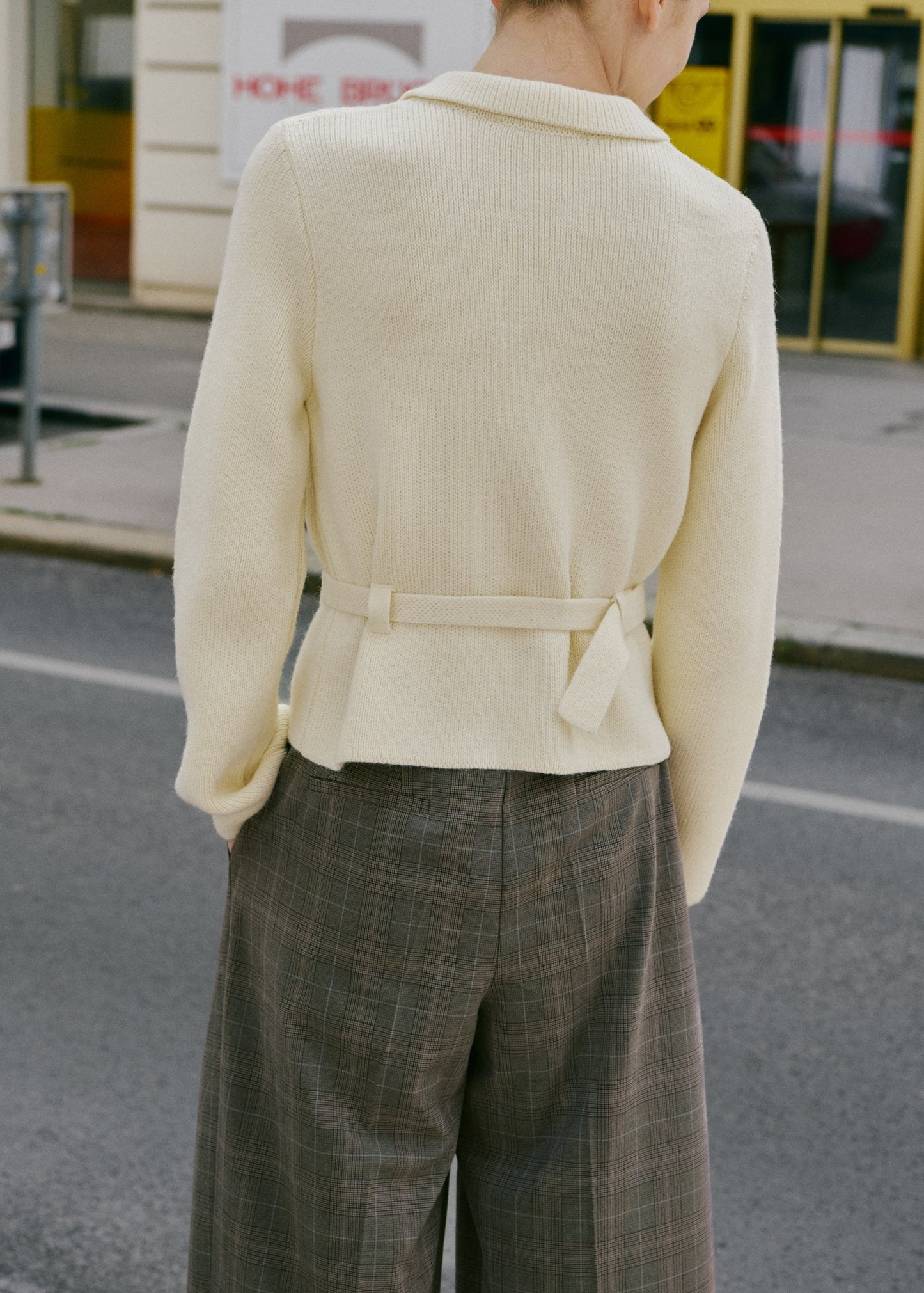 Knitted jacket with belt buckle