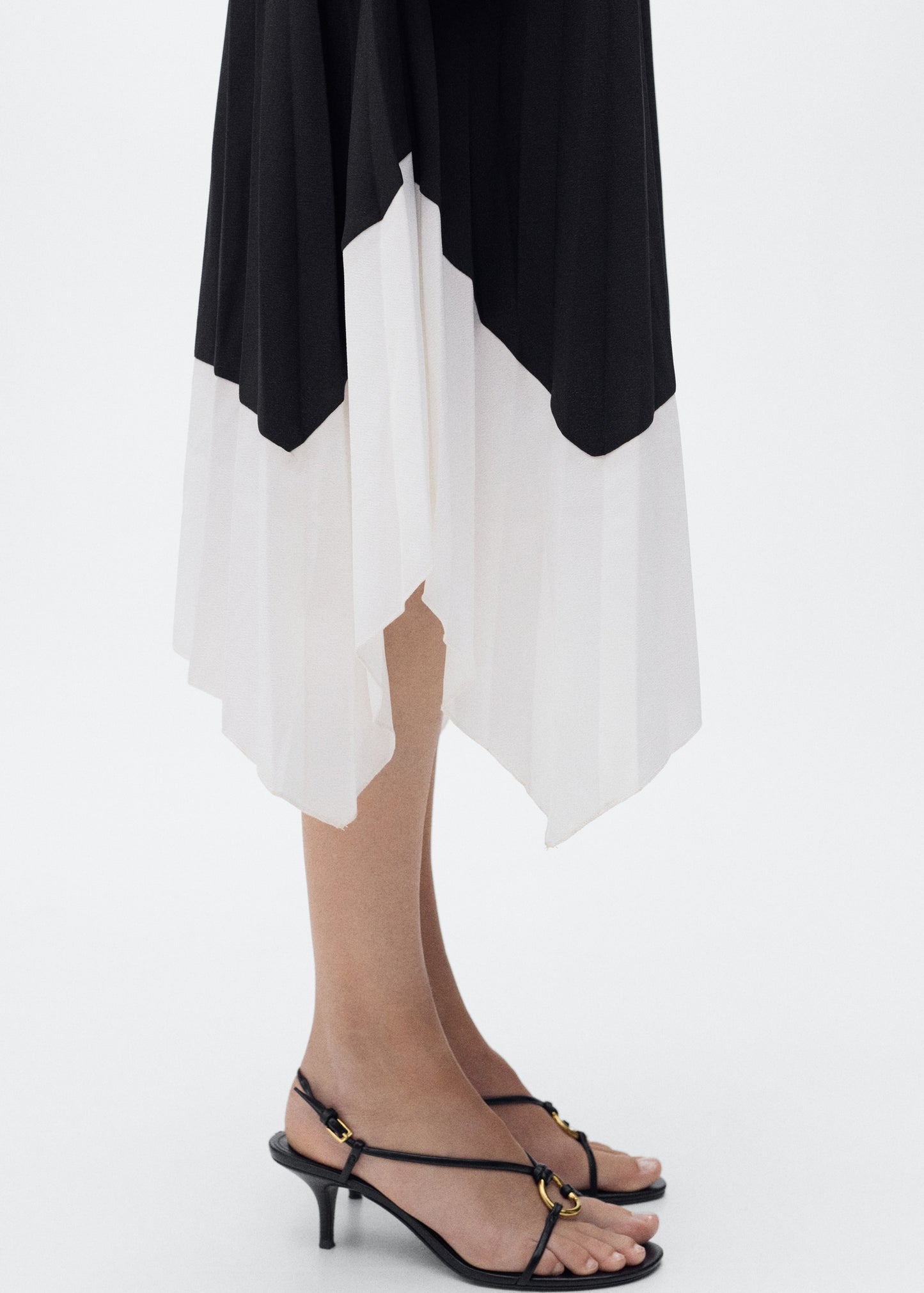 Pleated asymmetric skirt