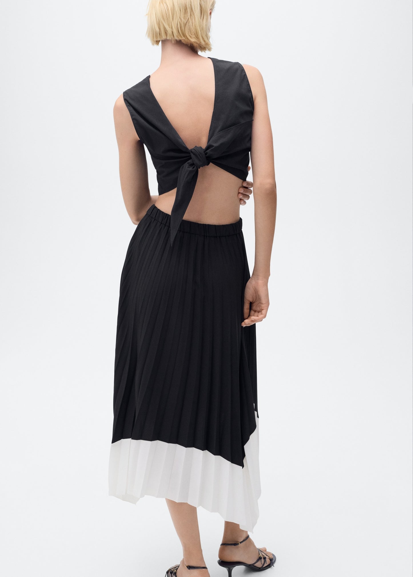 Pleated asymmetric skirt