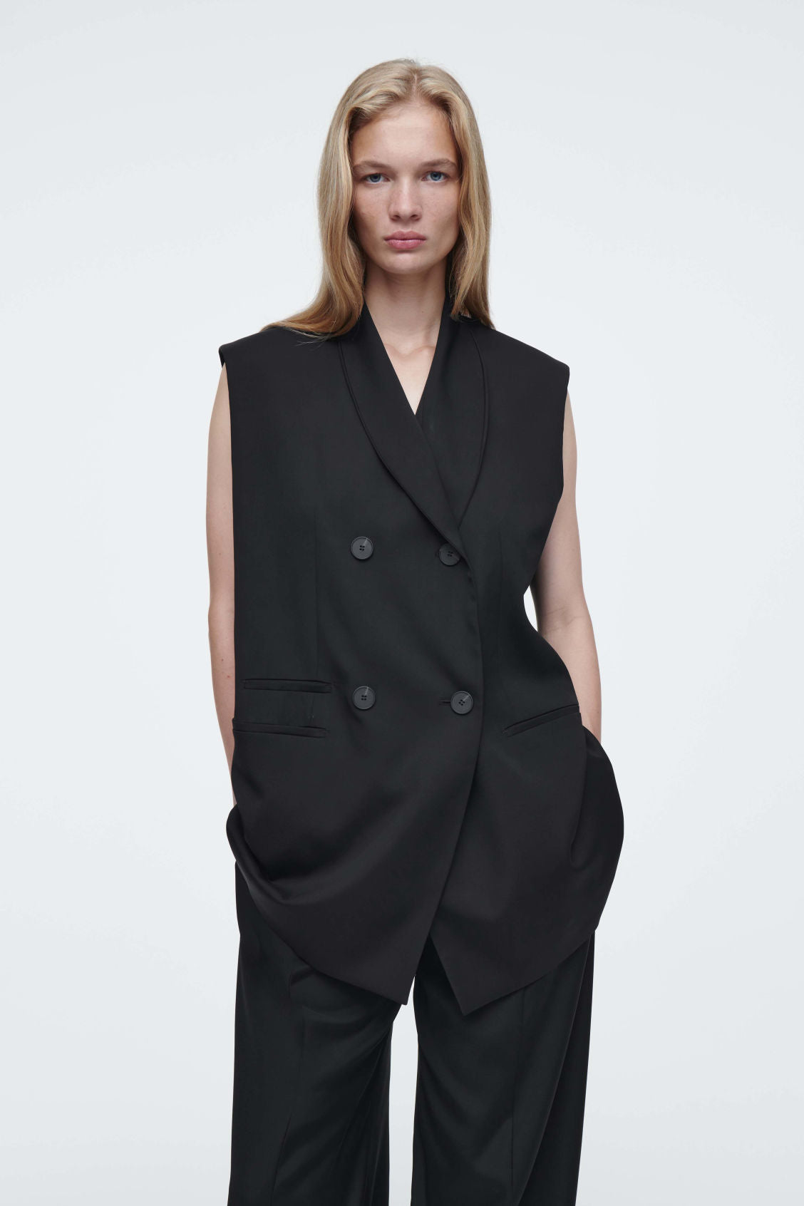 The elongated sleeveless blazer