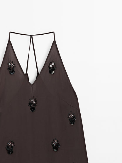 Flowy top with floral appliqués
