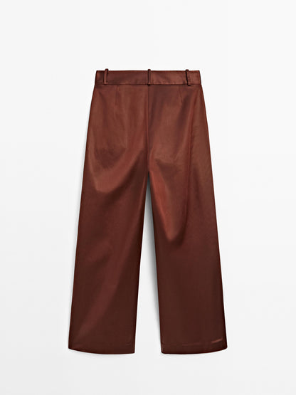 Shiny trousers with dart details