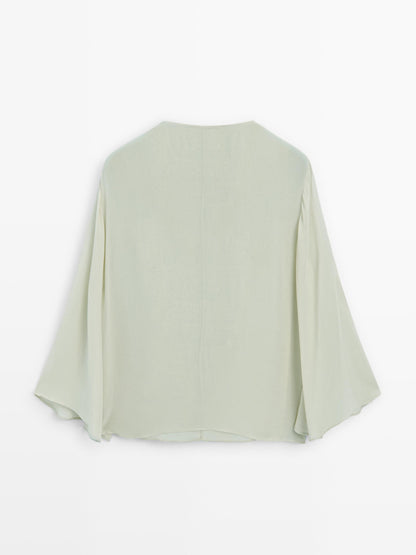 Flowing blouse with ruffled neckline