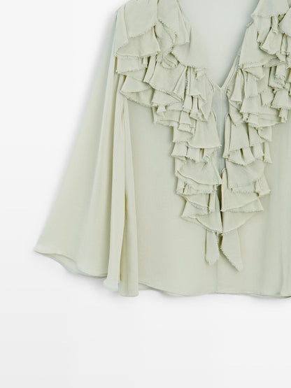Flowing blouse with ruffled neckline