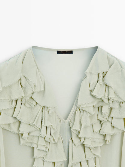 Flowing blouse with ruffled neckline