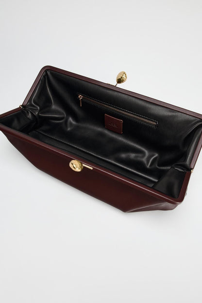 Leather clutch bag with metal detail