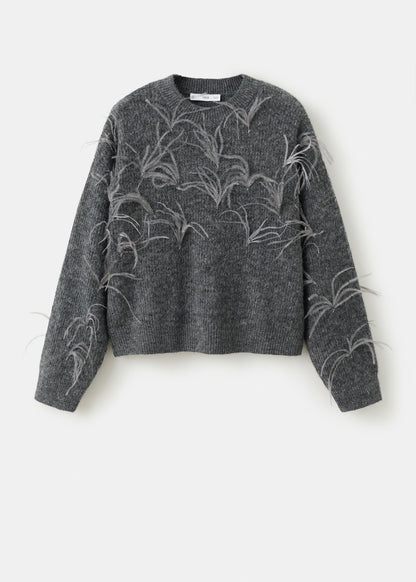 Knitted sweater with feathers