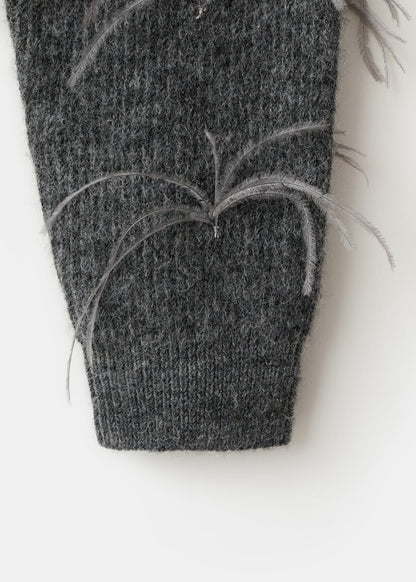 Knitted sweater with feathers