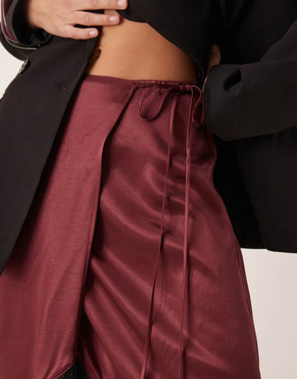 Satin wrap skirt with fringe hem in burgundy