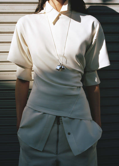 Fitted cotton t-shirt with asymmetrical hem