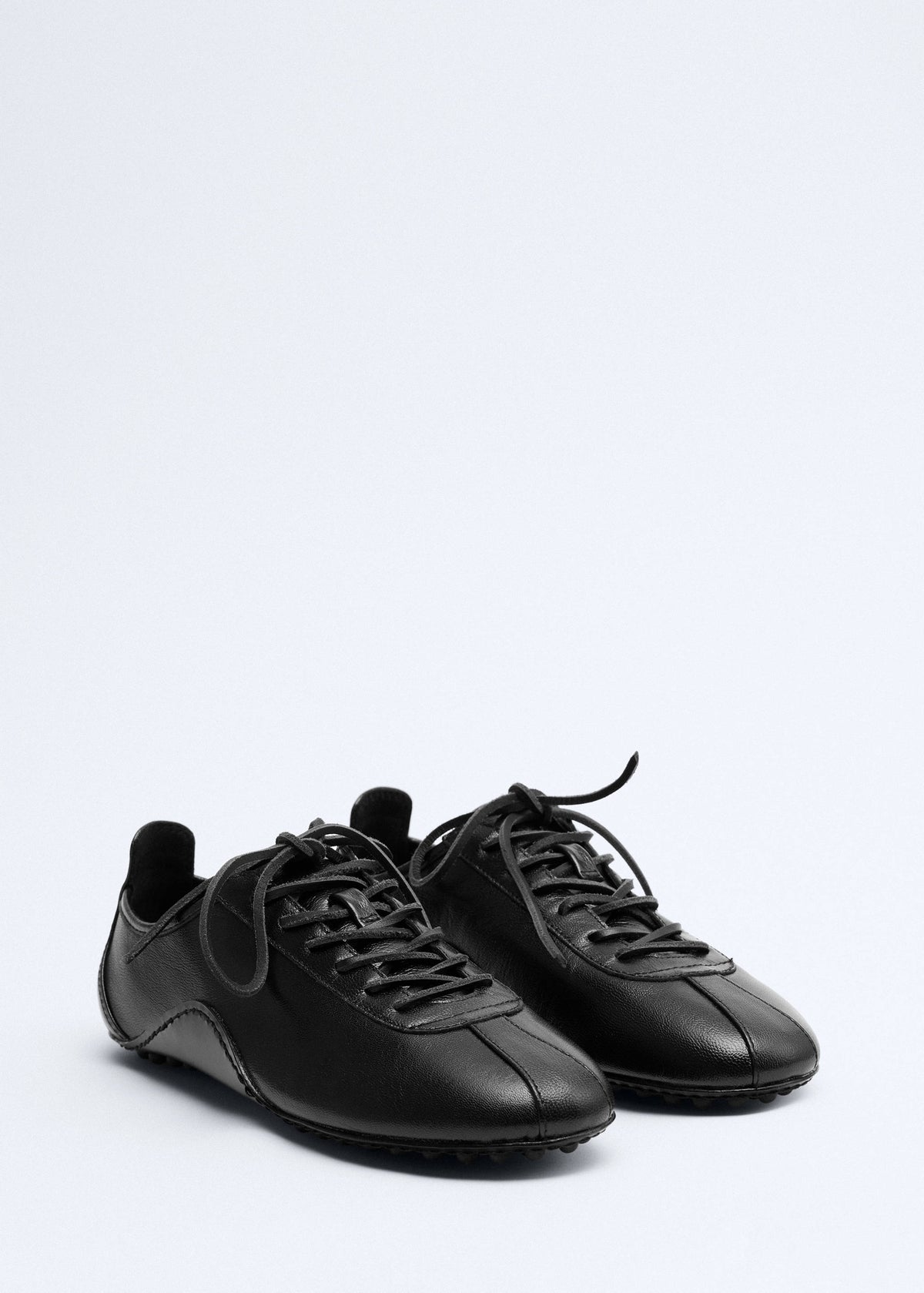 Leather trainer with stitched sole