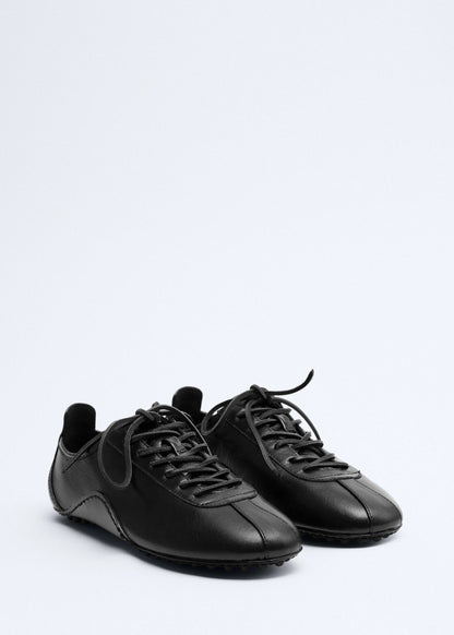 Leather trainer with stitched sole