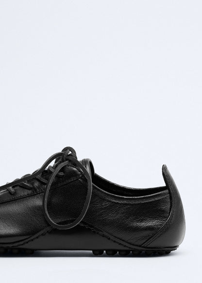 Leather trainer with stitched sole