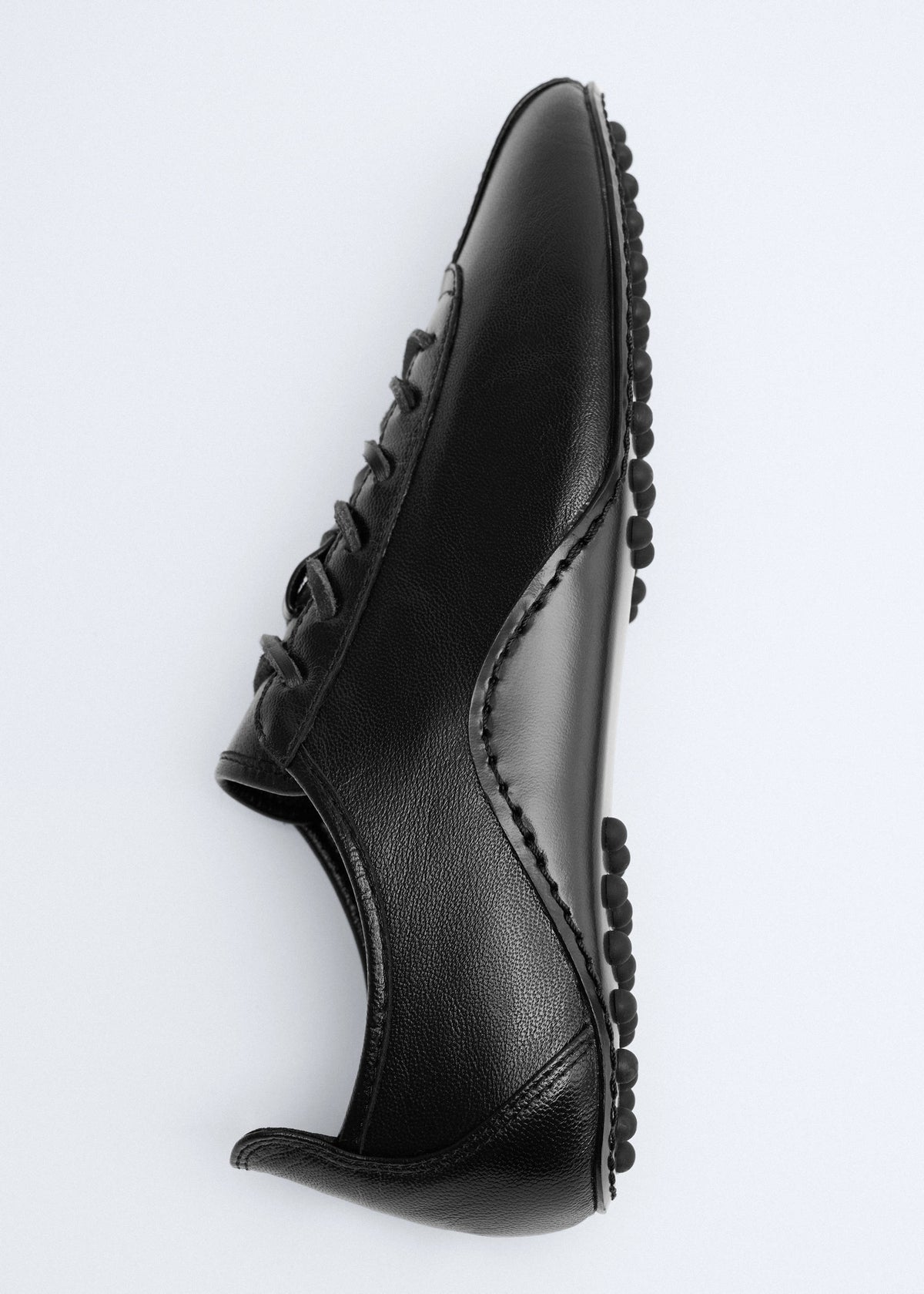 Leather trainer with stitched sole