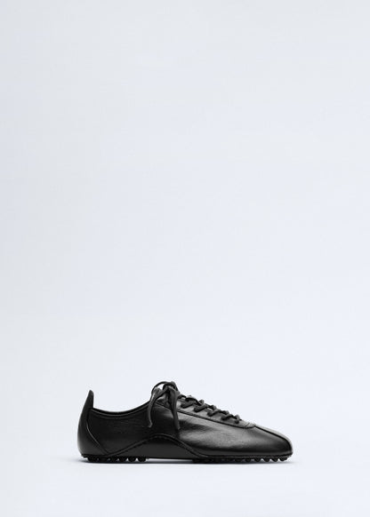 Leather trainer with stitched sole