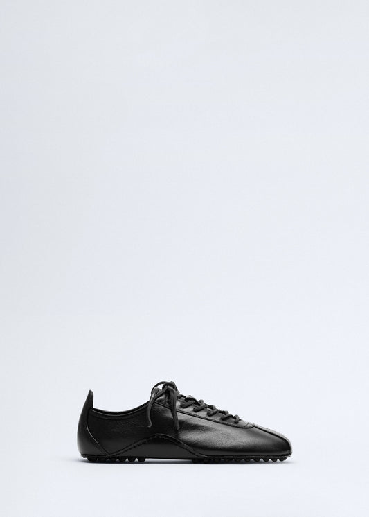 Leather trainer with stitched sole