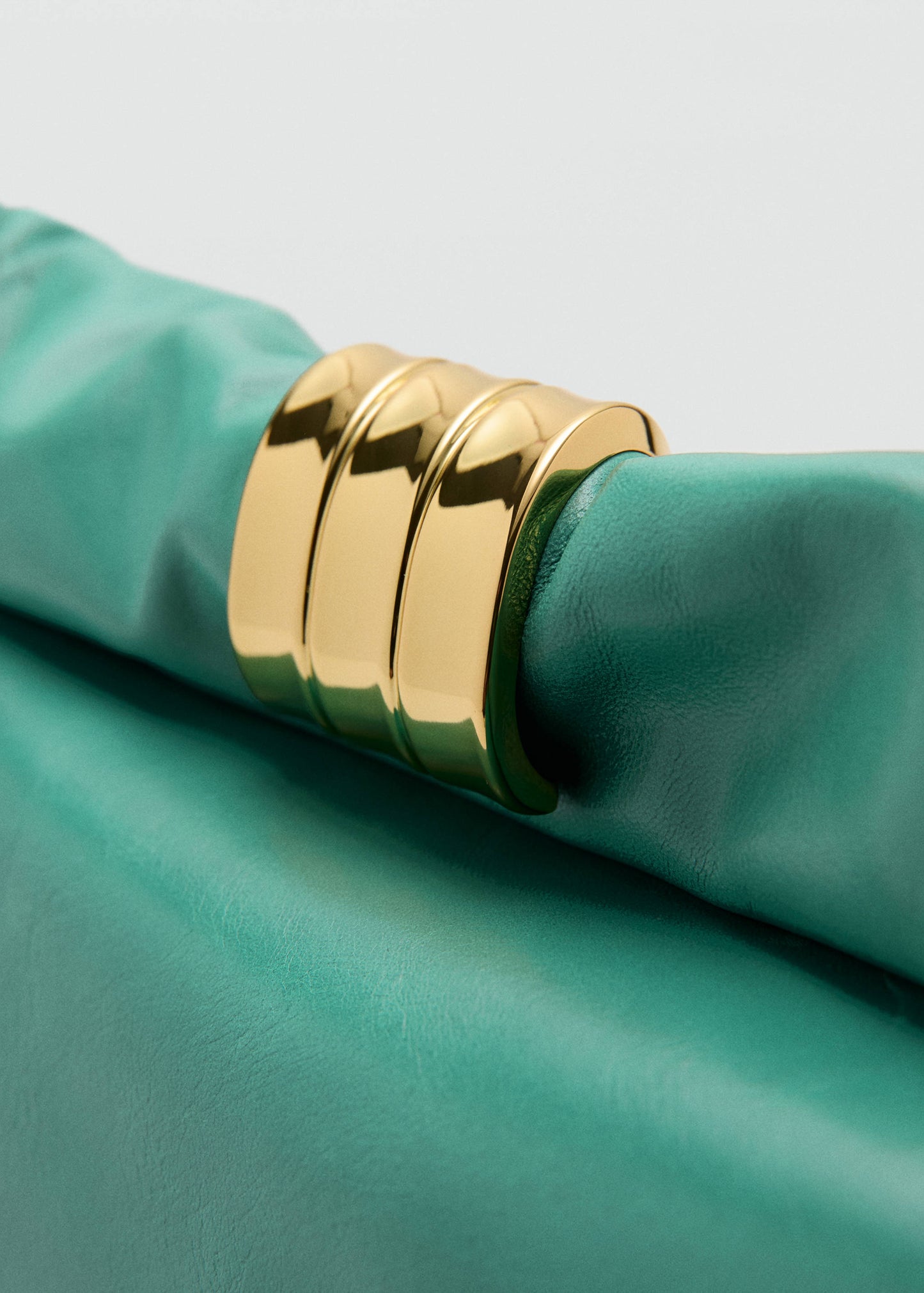 Leather clutch bag with metallic appliqué