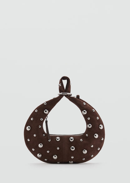 Leather handbag with metallic balls appliqué