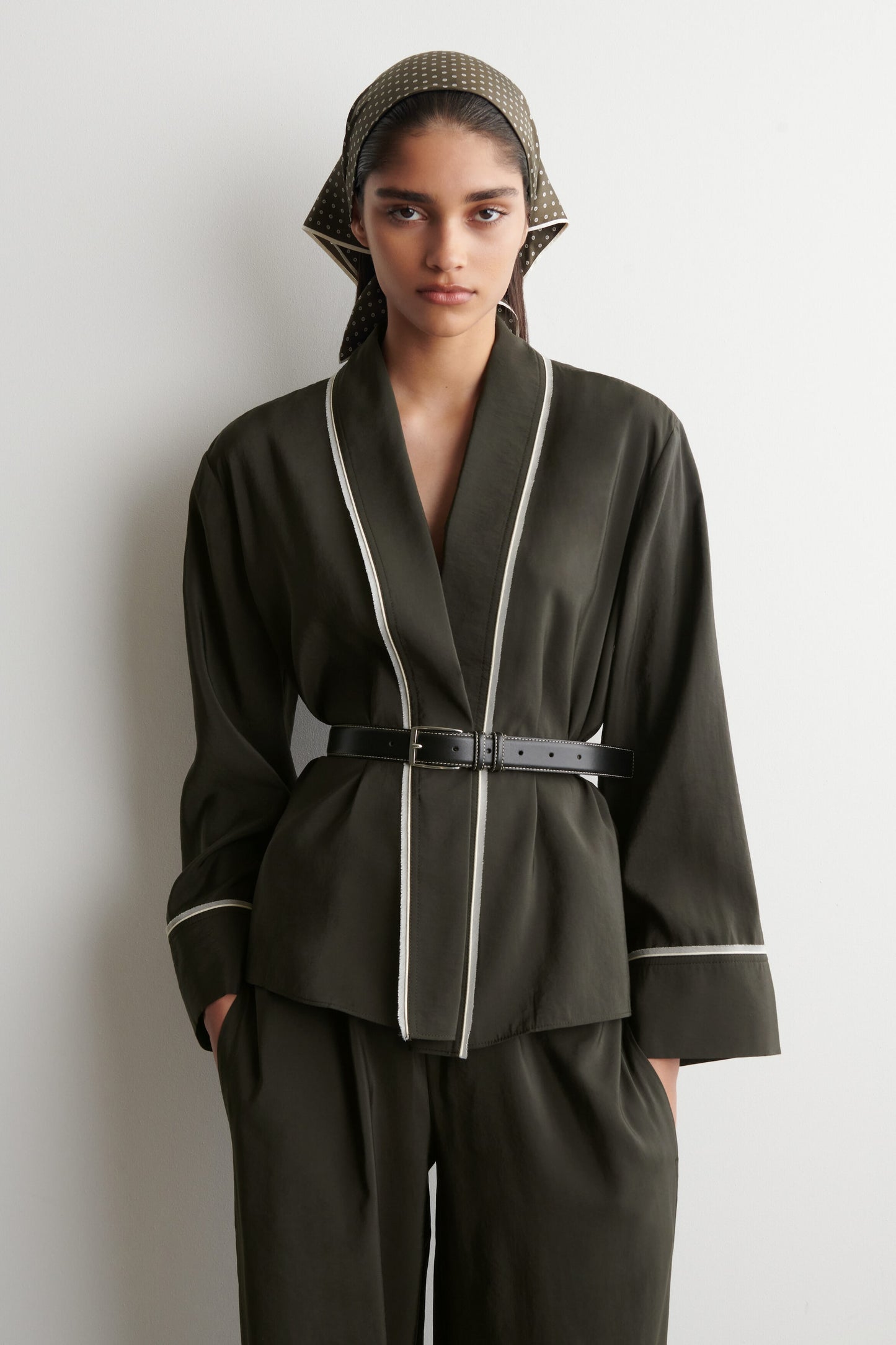 Contrast-piped belted wrap top